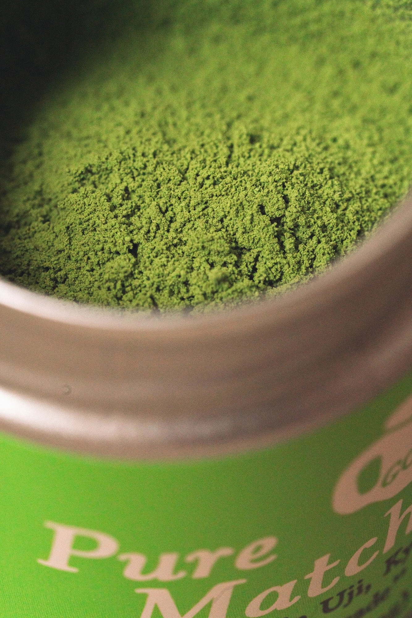Pure Matcha: an open tin seen from above, full of green powder