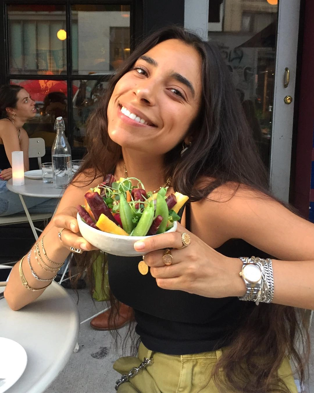 Bianca Valle smiling at a café table with a salad